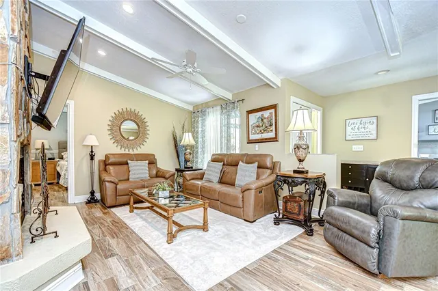a view of a hallway with closet and wooden floor