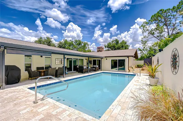 a view of a swimming pool with a yard