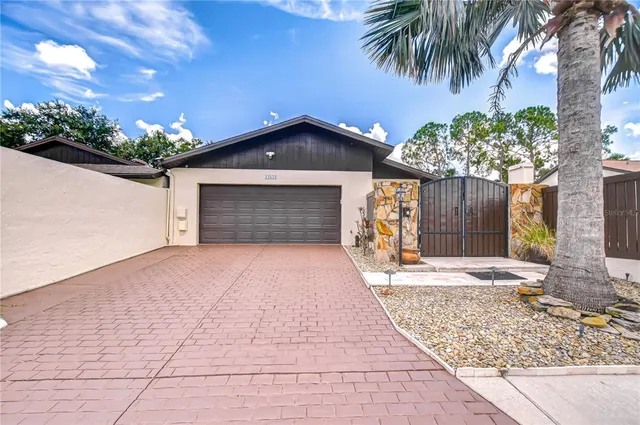 a view of a swimming pool with a bench and trees in the background
