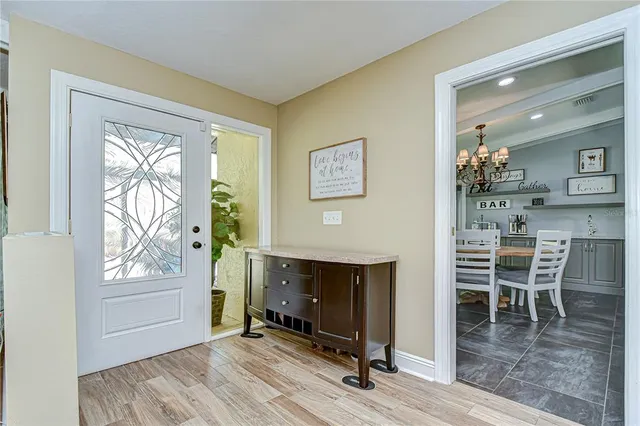 a kitchen with a stove and a table chair
