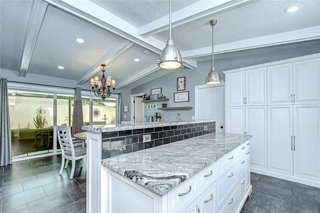 a large kitchen with a stove and large window