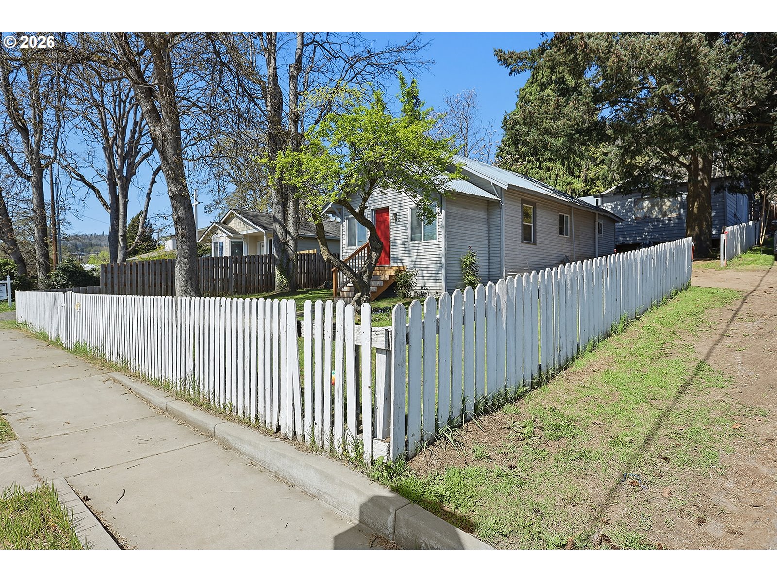 320 East Steuben Street Bingen, WA 98605 - Photo 27 of 41 a view of a house with a small yard and wooden fence