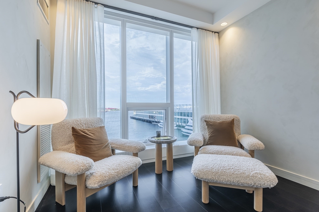 150 Seaport Boulevard, Unit 6D Boston, MA 02210 - Photo 14 of 30 a living room with furniture and a chair