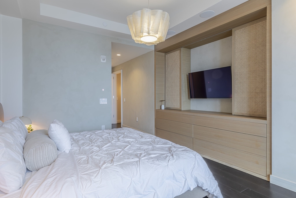 150 Seaport Boulevard, Unit 6D Boston, MA 02210 - Photo 16 of 30 a bedroom with a bed and a television