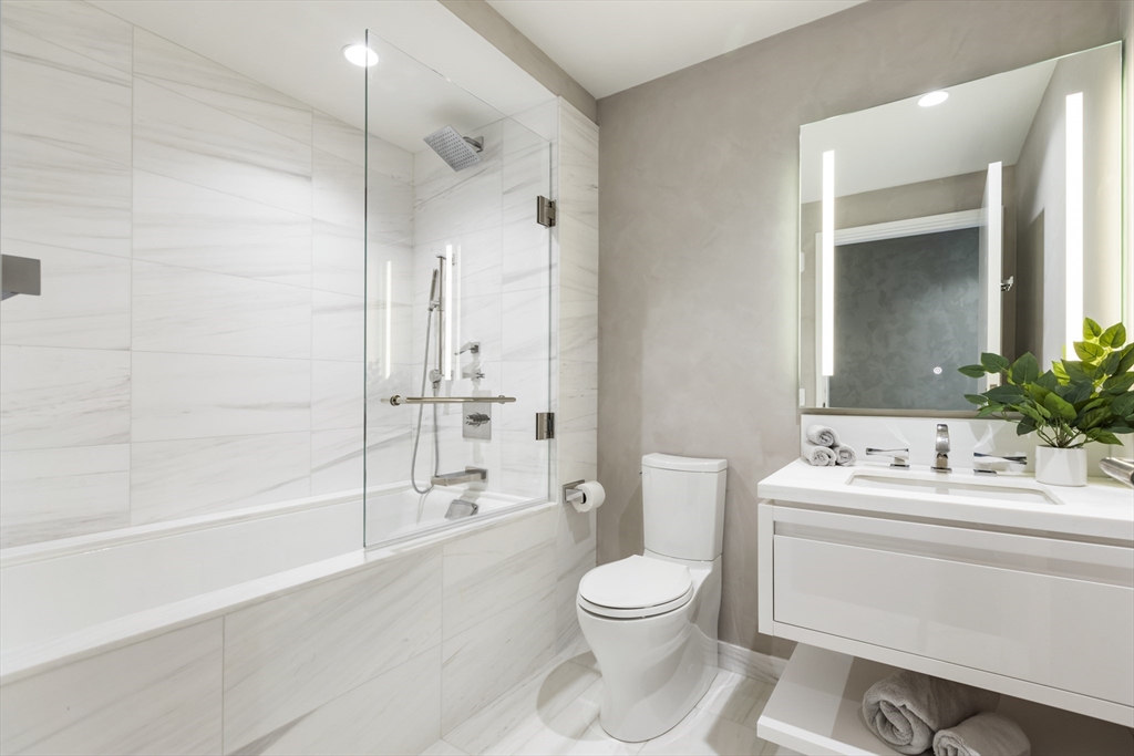 150 Seaport Boulevard, Unit 6D Boston, MA 02210 - Photo 19 of 30 a bathroom with a toilet sink and shower