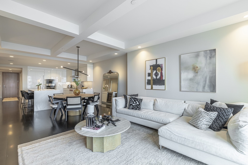 150 Seaport Boulevard, Unit 6D Boston, MA 02210 - Photo 2 of 30 a living room with furniture and a wooden floor