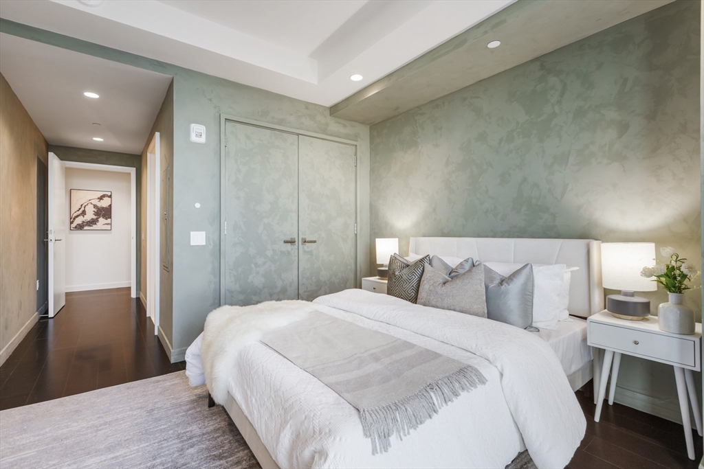 150 Seaport Boulevard, Unit 6D Boston, MA 02210 - Photo 21 of 30 a bedroom with a bed and painting on the wall
