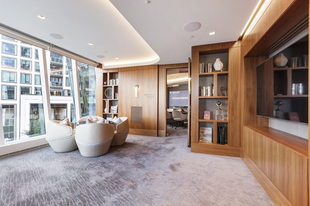 150 Seaport Boulevard, Unit 6D Boston, MA 02210 - Photo 26 of 30 a living room with furniture and a potted plant