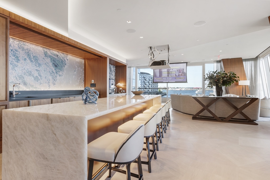 150 Seaport Boulevard, Unit 6D Boston, MA 02210 - Photo 28 of 30 a living room with furniture a rug and a large window