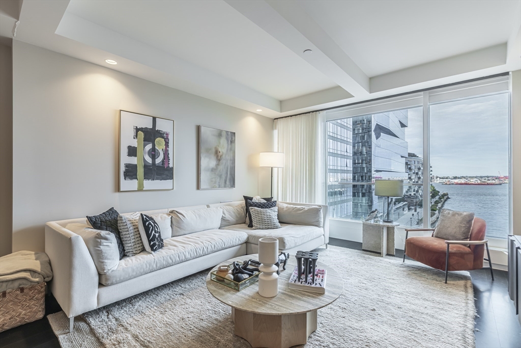 150 Seaport Boulevard, Unit 6D Boston, MA 02210 - Photo 3 of 30 a living room with furniture and a large window