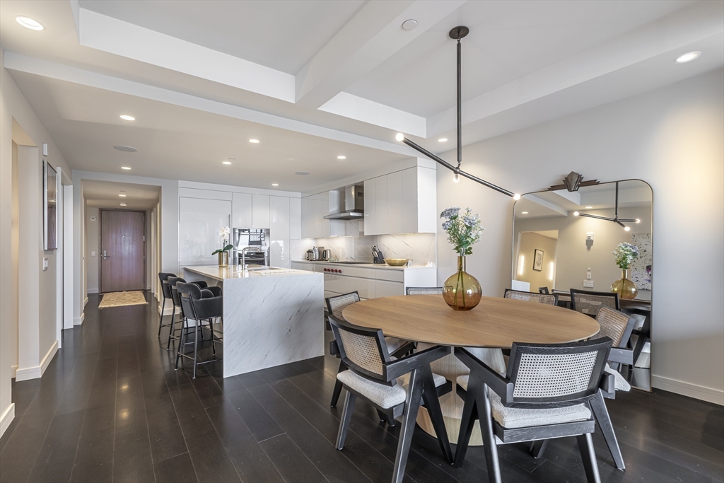 150 Seaport Boulevard, Unit 6D Boston, MA 02210 - Photo 5 of 30 a dining room with furniture and wooden floor
