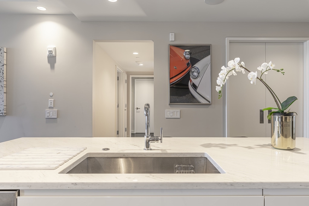 150 Seaport Boulevard, Unit 6D Boston, MA 02210 - Photo 10 of 30 a kitchen with a sink and a mirror