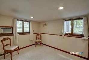 a view of a livingroom with furniture and staircase