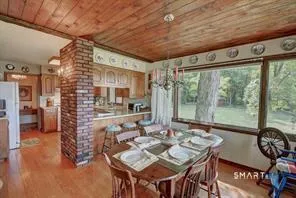 a view of a dining room with furniture window and outside view