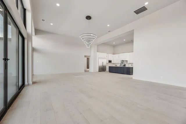 a view of a kitchen with a sink and a refrigerator