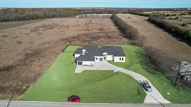 a view of a big yard with an outdoor seating