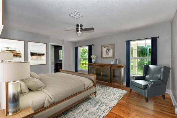 a bedroom with a bed a couch and dresser