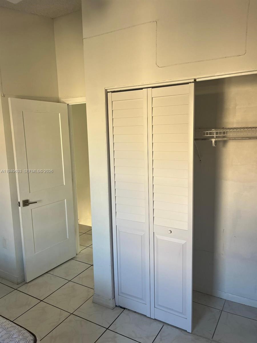 5580 West 26th Court, Unit 208 Hialeah, FL 33016 - Photo 6 of 12 a bathroom with a glass door shower