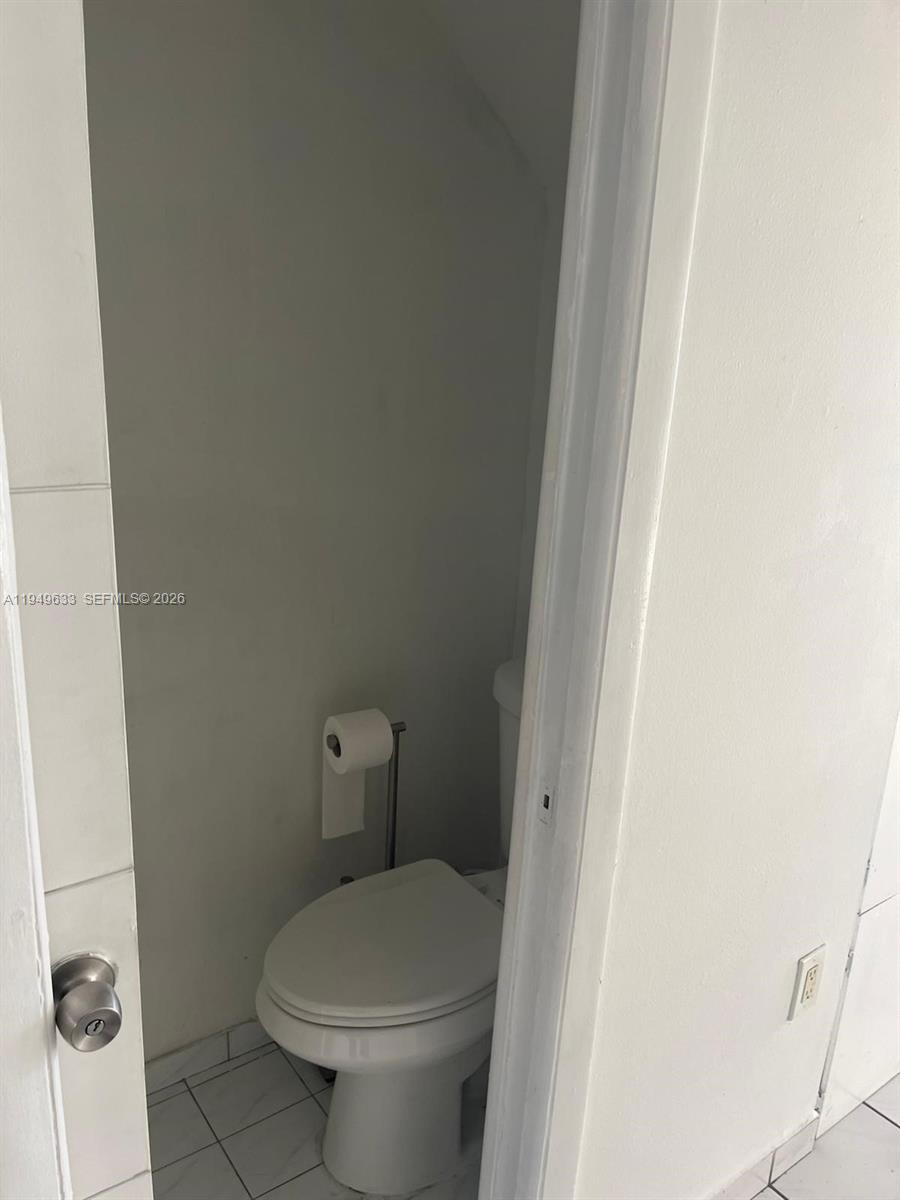 5580 West 26th Court, Unit 208 Hialeah, FL 33016 - Photo 9 of 12 a white toilet sitting next to a shower