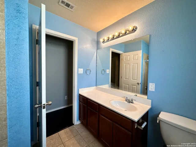 an empty room with a ceiling fan and a window