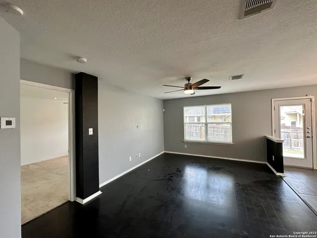a view of a kitchen with a sink and chandelier