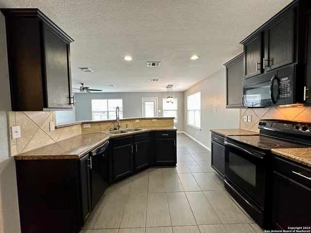 a bathroom with a tub sink and mirror