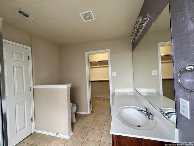 a bathroom with a tub and a mirror