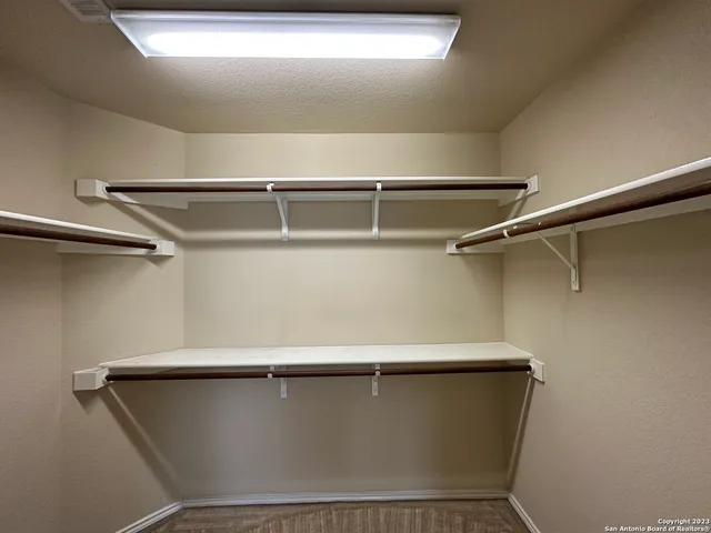 a en suite bathroom with a granite countertop toilet sink and mirror