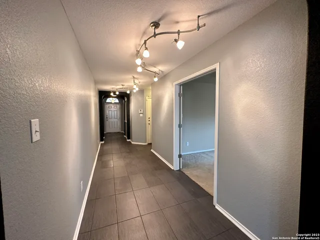 a view of a hallway with wooden floor
