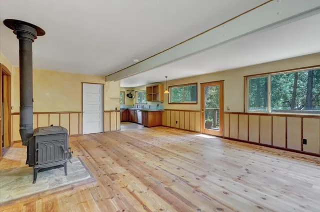 a kitchen with a stove a sink and a window