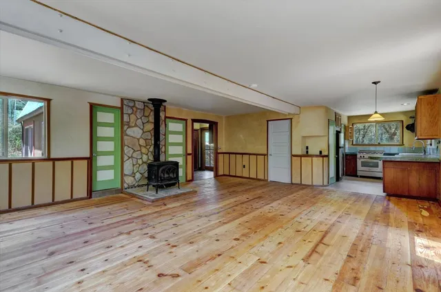 a view of a hallway with furniture and a window