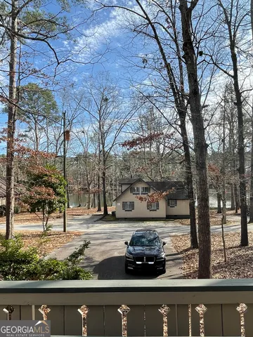 a view of a yard with cars parked