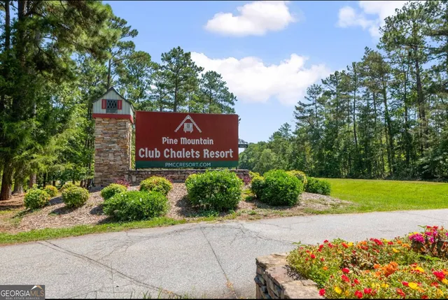 a sign that is sitting in front of flowers