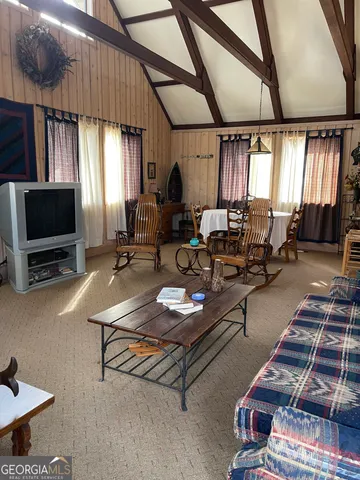 a living room with furniture a window and a flat screen tv