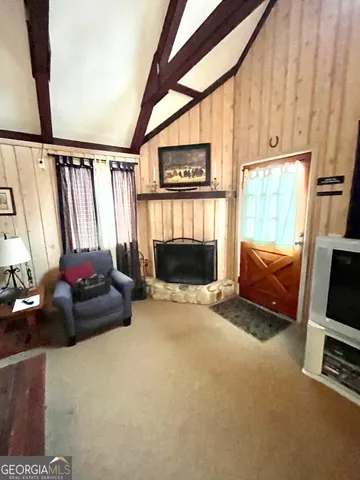 a living room with furniture a window and a flat screen tv