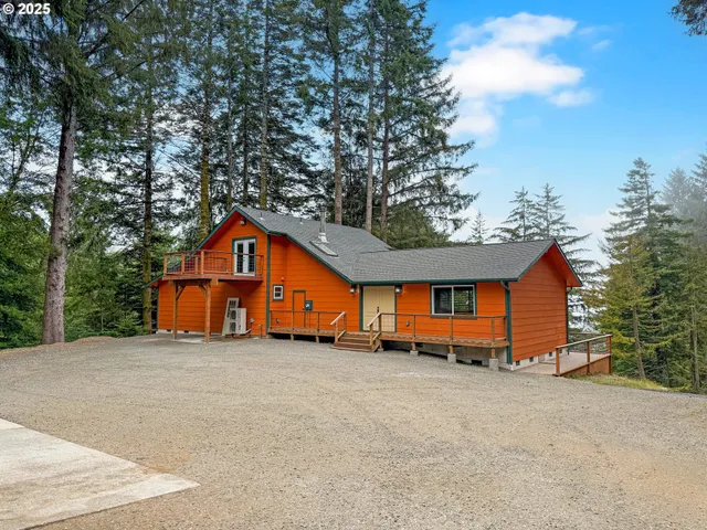 a view of a house with a big yard and large trees