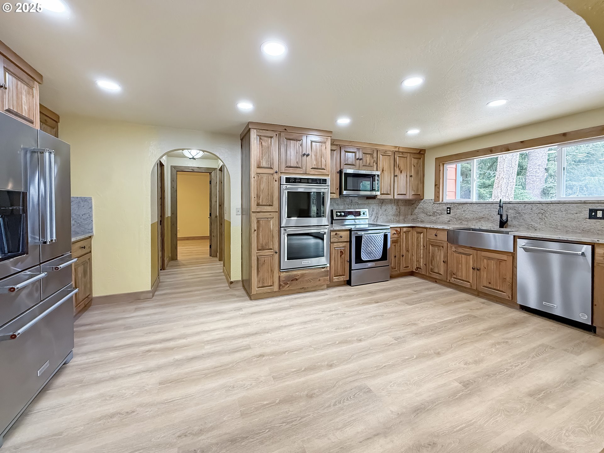 20313 Whaleshead Road Brookings, OR 97415 - Photo 11 of 41 a large kitchen with cabinets and stainless steel appliances