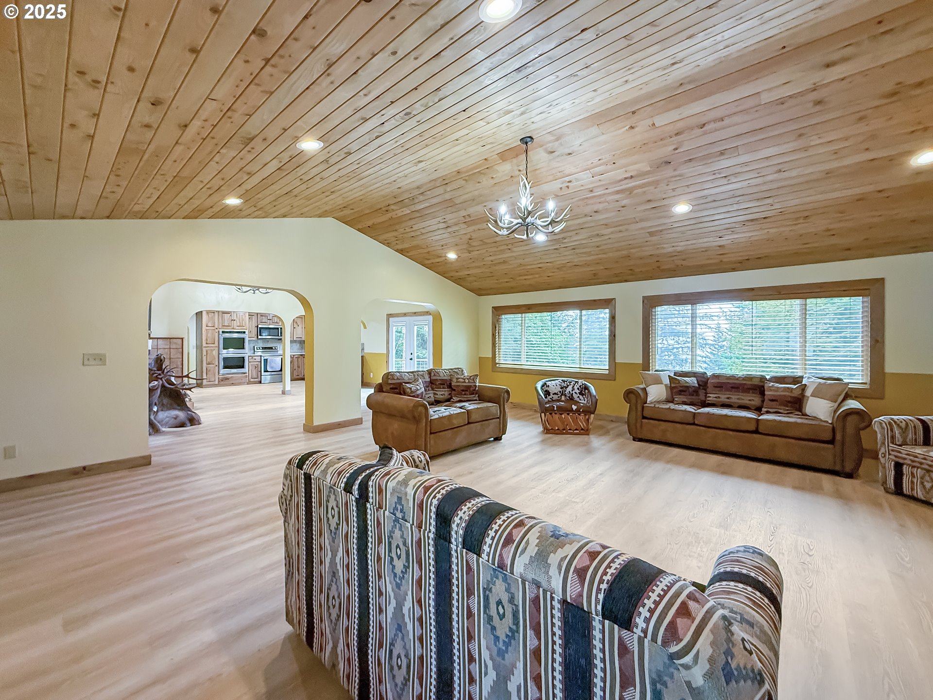 20313 Whaleshead Road Brookings, OR 97415 - Photo 16 of 41 a bedroom with furniture and a chandelier