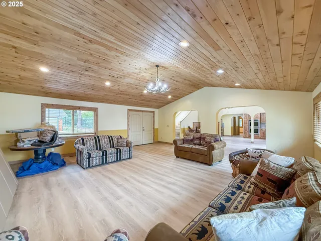 a living room with furniture and a ceiling fan
