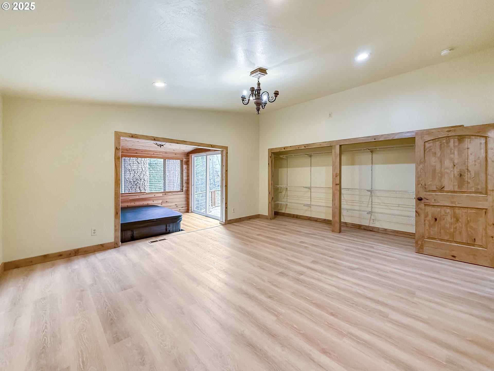 20313 Whaleshead Road Brookings, OR 97415 - Photo 19 of 41 a view of an empty room with a window and wooden floor