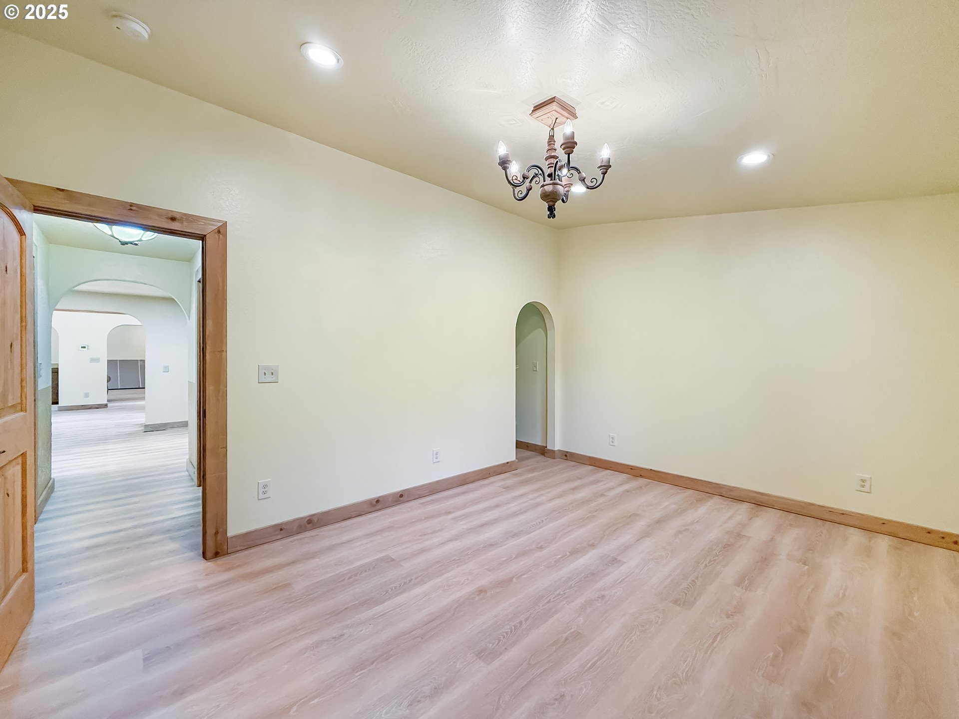 20313 Whaleshead Road Brookings, OR 97415 - Photo 25 of 41 a view of a room with wooden floor and chandelier