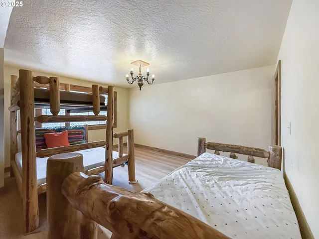 a bedroom with furniture and a chandelier