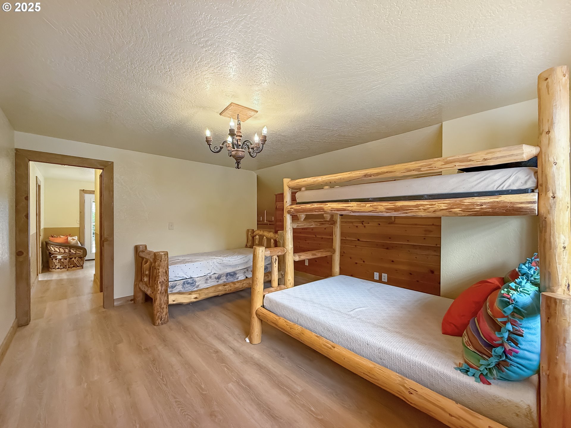 20313 Whaleshead Road Brookings, OR 97415 - Photo 36 of 41 a bedroom with furniture and a chandelier