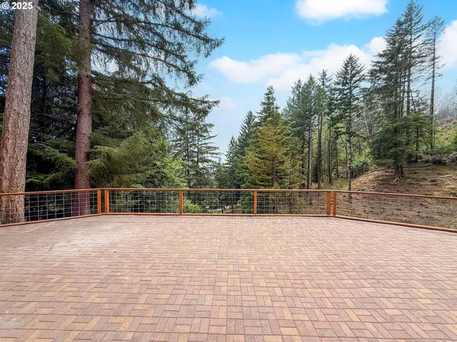 a large kitchen with stainless steel appliances granite countertop a stove refrigerator and a microwave