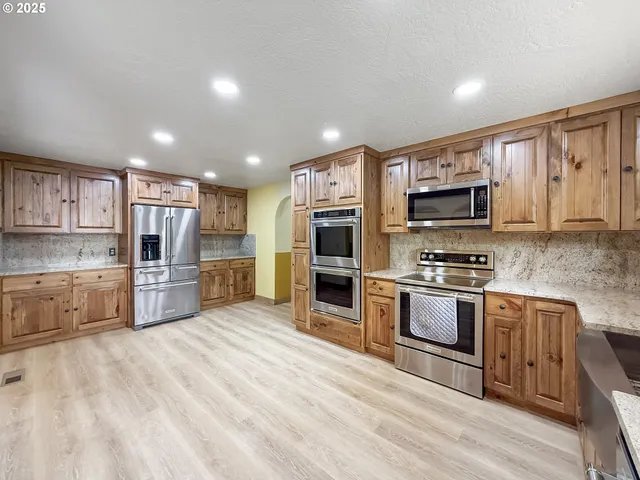a kitchen with stainless steel appliances granite countertop a stove and a sink