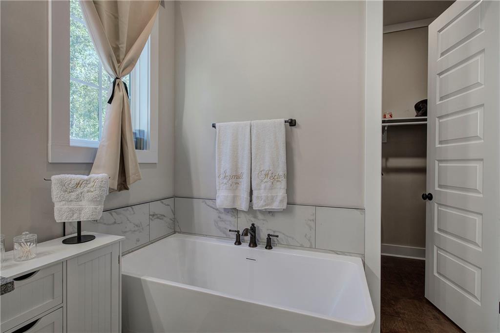 503 London Road Ball Ground, GA 30107 - Photo 25 of 55 a bathroom with a bathtub and a sink
