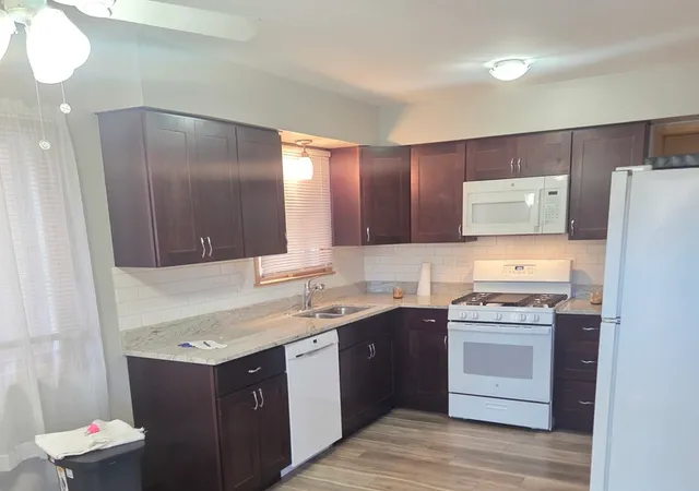 a kitchen with a sink and a stove top oven