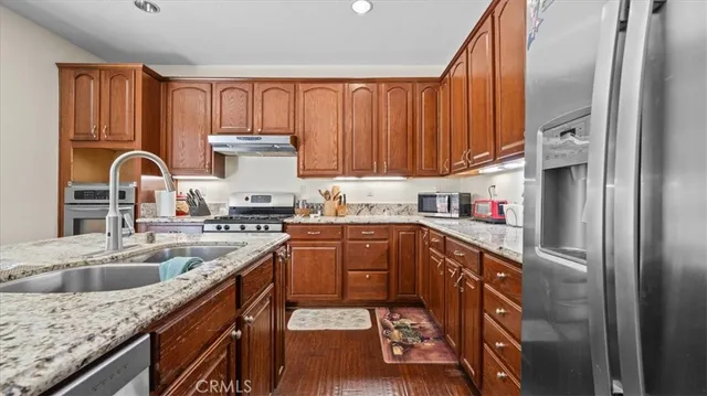 a kitchen with a sink refrigerator and cabinets