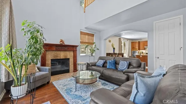 a living room with furniture fireplace and a large window