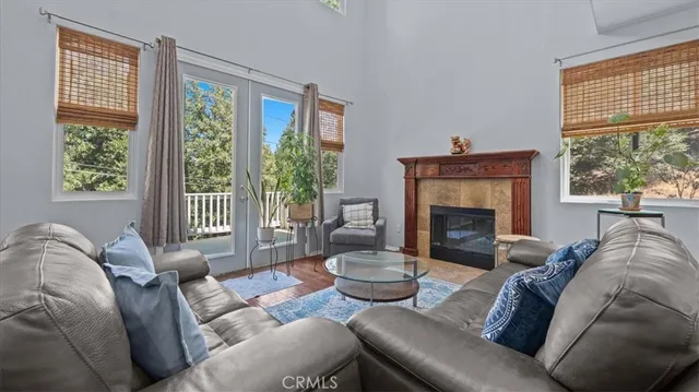 a living room with furniture and a floor to ceiling window
